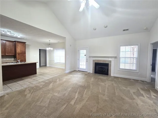 a view of an empty room with a kitchen and a kitchen
