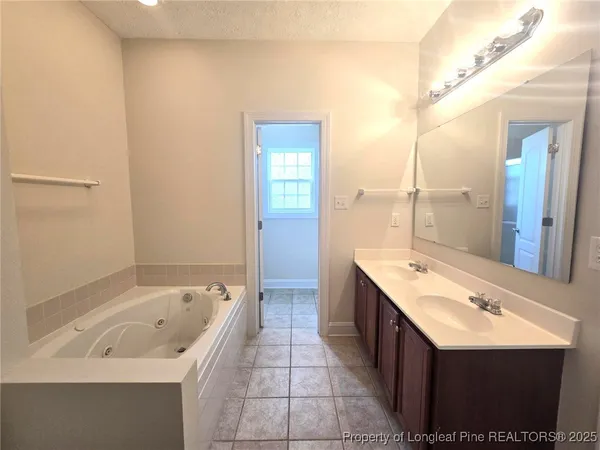 a white bath tub sitting next to a white sink