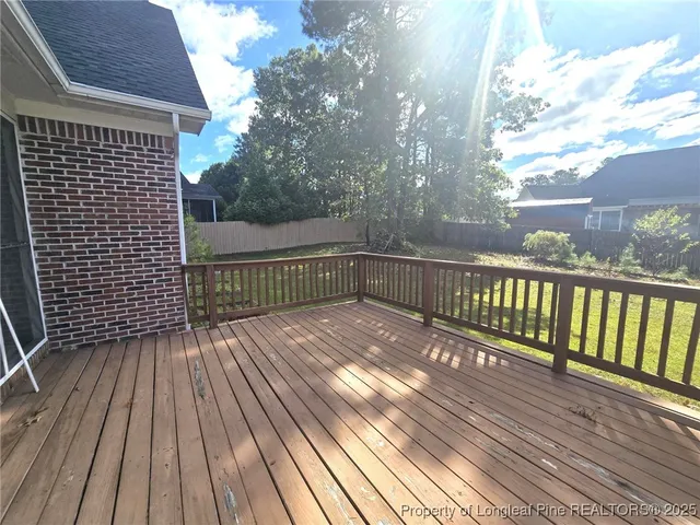 a view of a house with a yard and fence