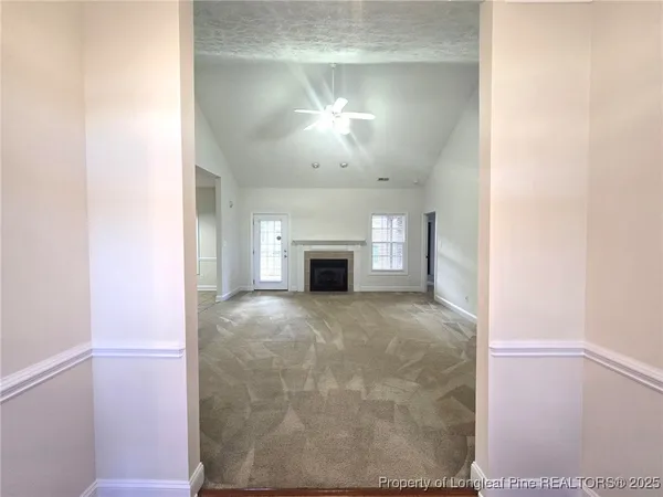 a view of empty room with a fireplace