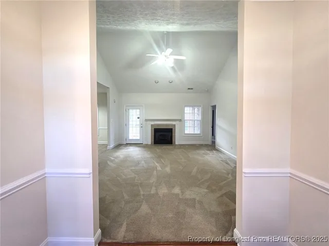 a view of empty room with a fireplace