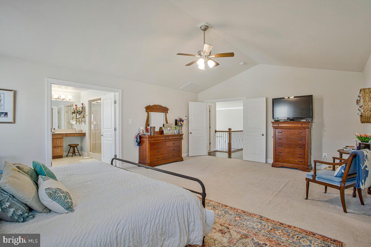 54 Simmons Ridge Road Prince Frederick, MD 20678 - Photo 32 of 55 a bedroom with a bed and a chandelier