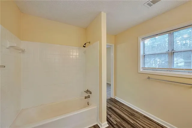 a bathroom with a bathtub and a shower