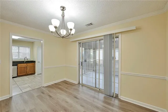 a view of an empty room with a kitchen
