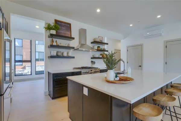 a kitchen with stainless steel appliances granite countertop a sink and a stove