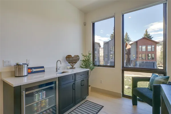 a kitchen with a sink cabinets and wooden floor