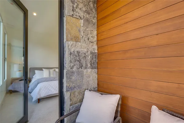 a bedroom with a bed and a chair