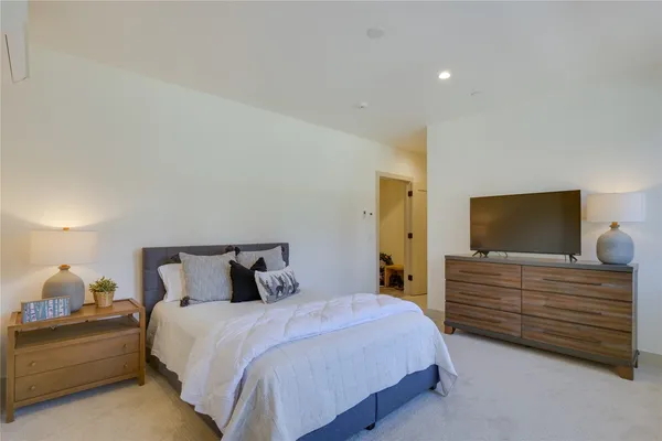 a bedroom with a bed and a television