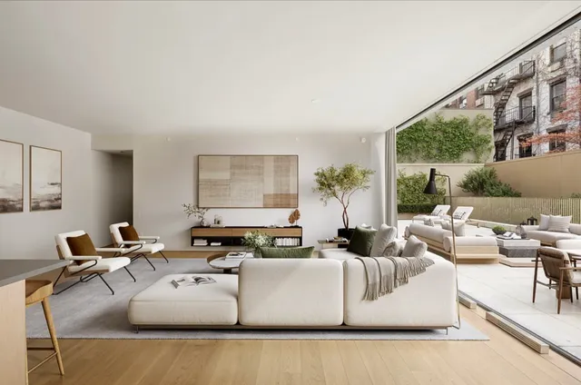 a living room with furniture a rug and a floor to ceiling window