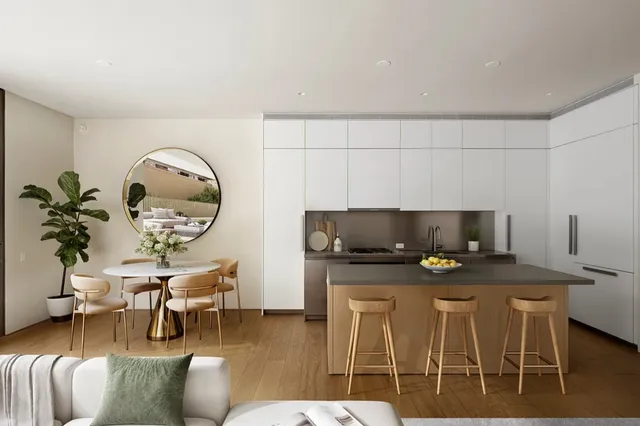 a kitchen with granite countertop a table chairs microwave and cabinets