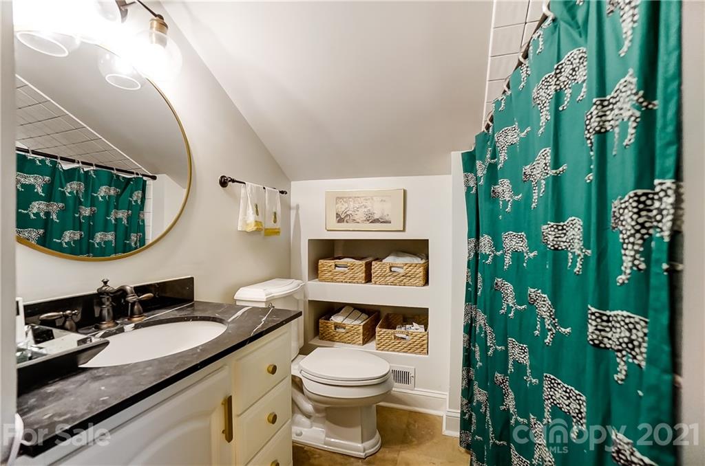 2610 Providence Road Charlotte, NC 28211 - Photo 15 of 37 a bathroom with a granite countertop toilet sink and mirror