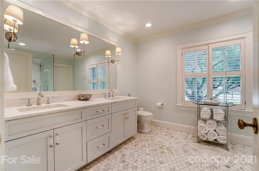 2610 Providence Road Charlotte, NC 28211 - Photo 17 of 37 a spacious bathroom with double vanity a window a double vanity and a mirror
