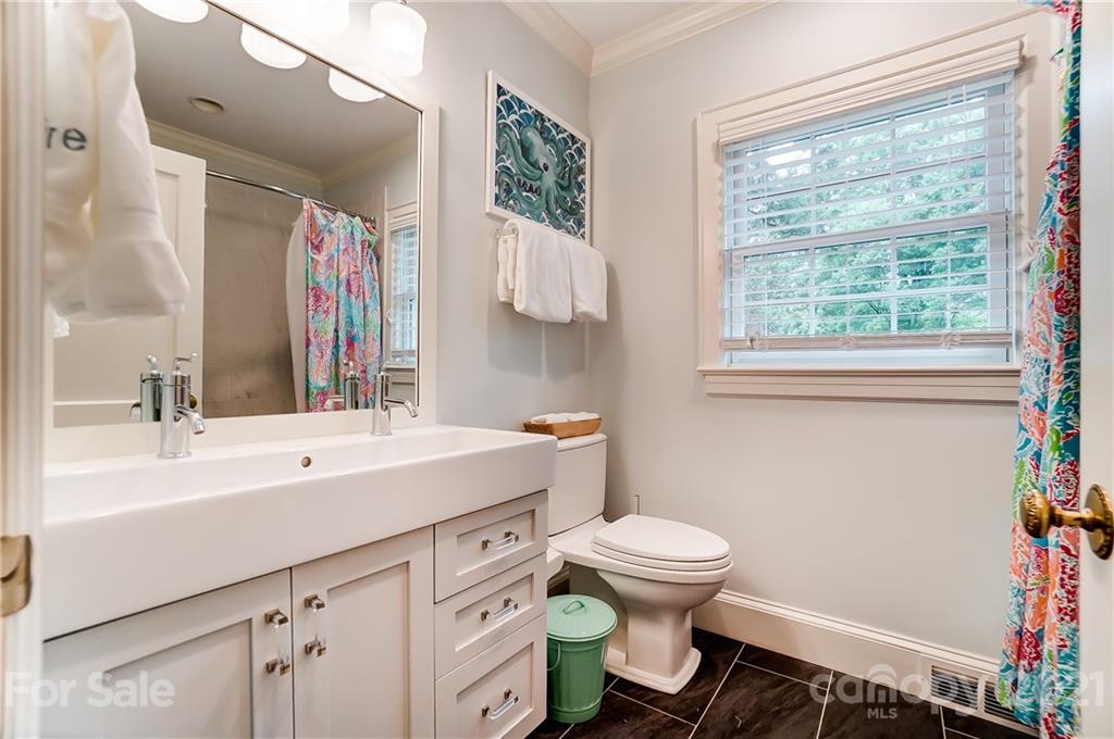 2610 Providence Road Charlotte, NC 28211 - Photo 21 of 37 a bathroom with a sink toilet and a mirror
