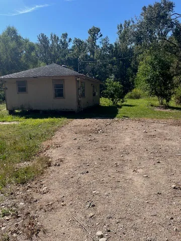 a backyard of a house with lots of green space