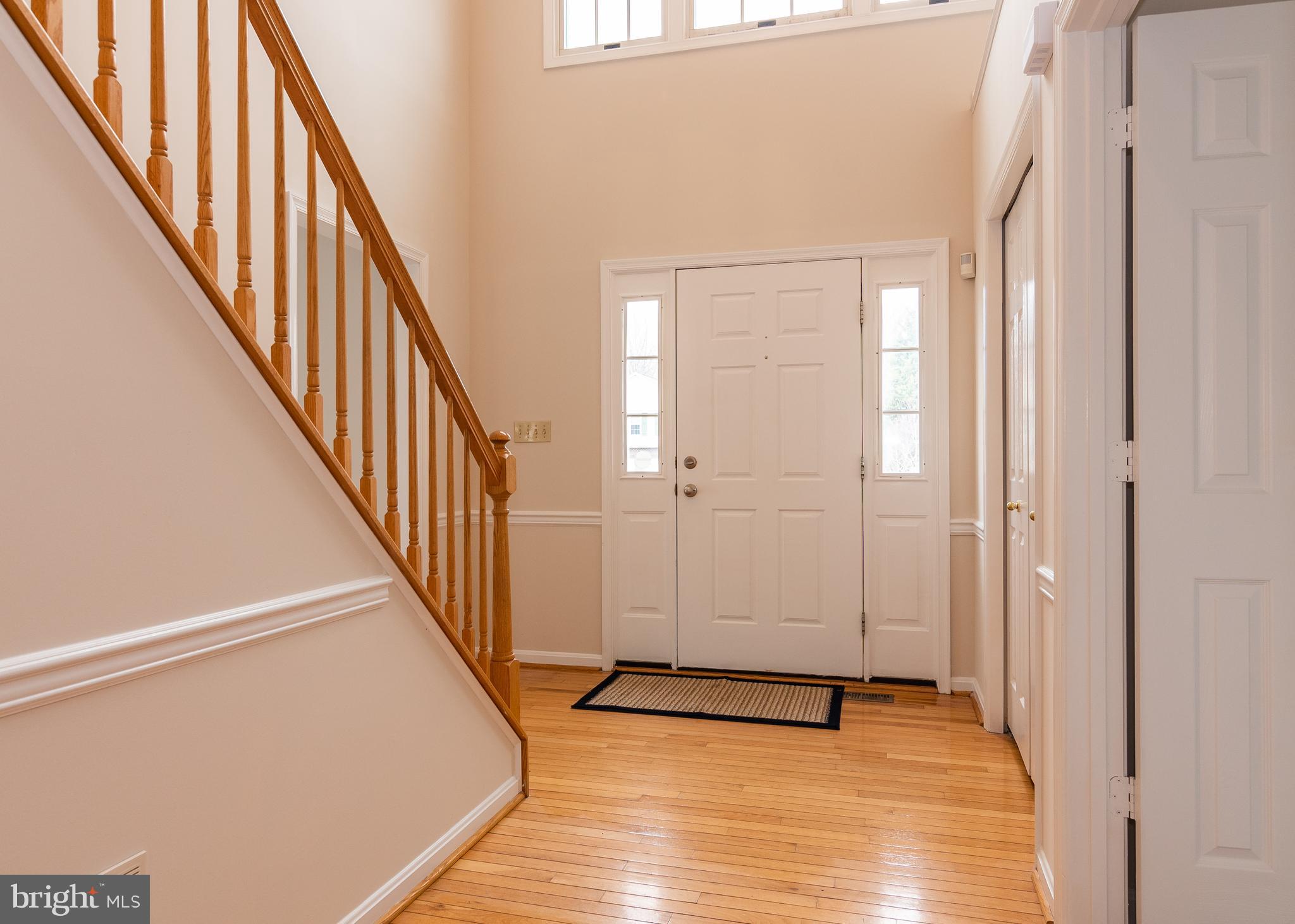Two story hardwood foyer
