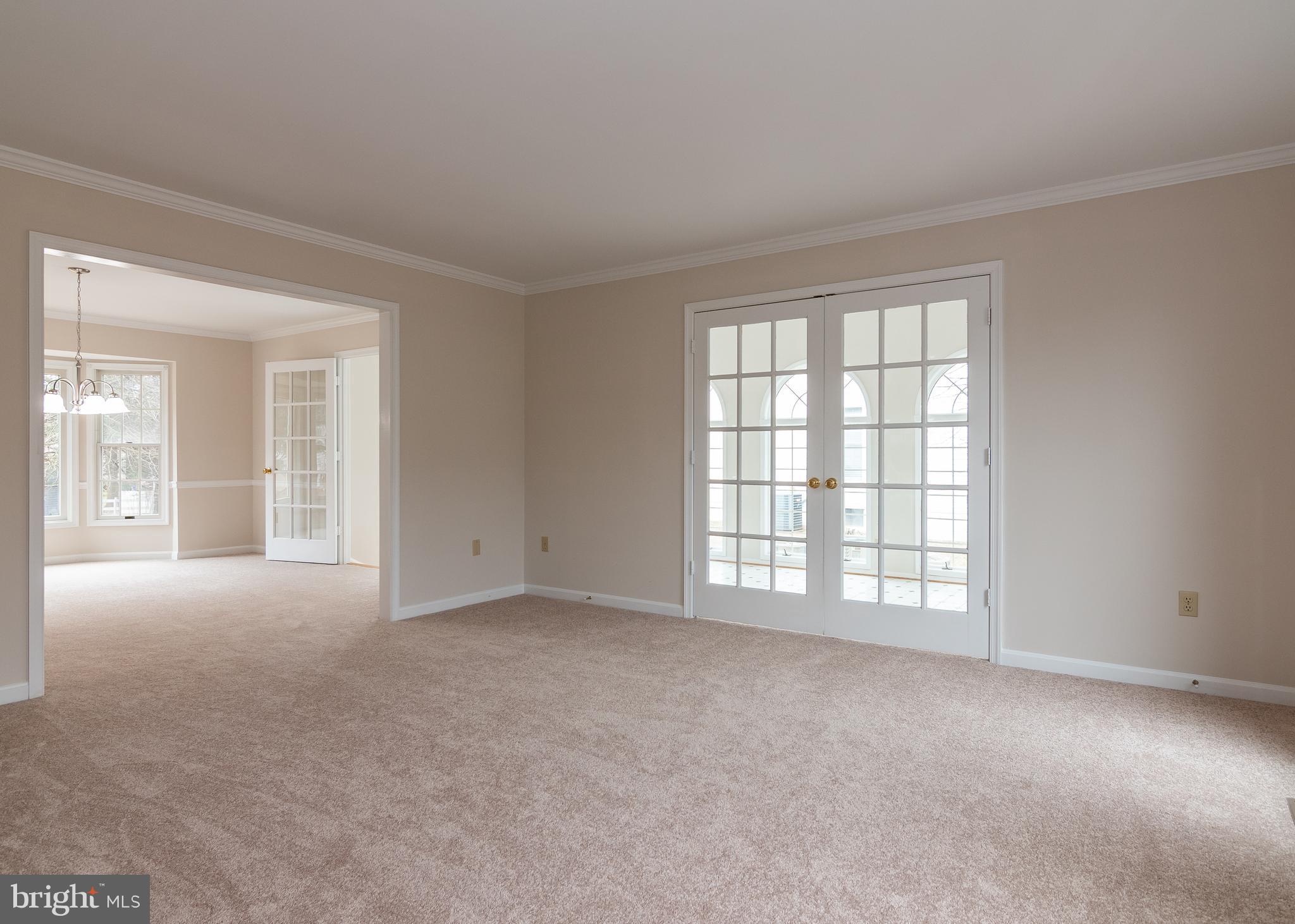 Living room with french doors to sun room