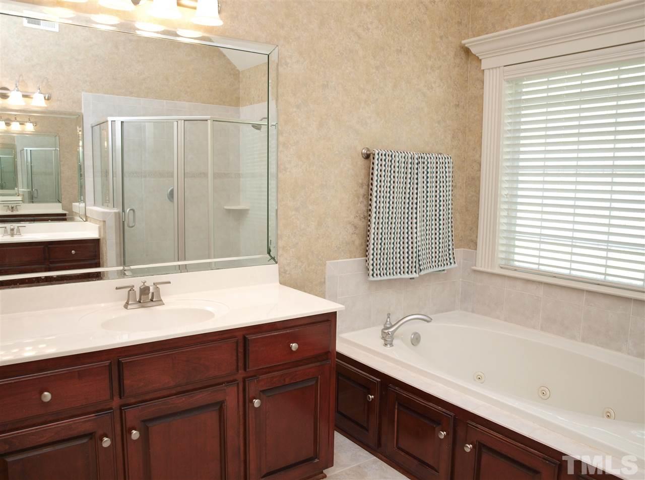 3317 La Costa Way Raleigh, NC 27610 - Photo 11 of 25 a bathroom with a sink double vanity and bathtub