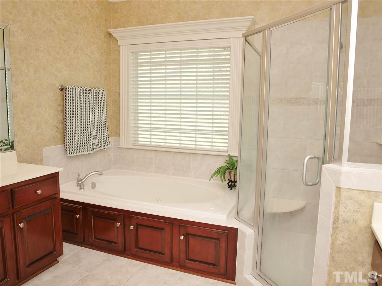 3317 La Costa Way Raleigh, NC 27610 - Photo 12 of 25 a spacious bathroom with a tub sink and mirror