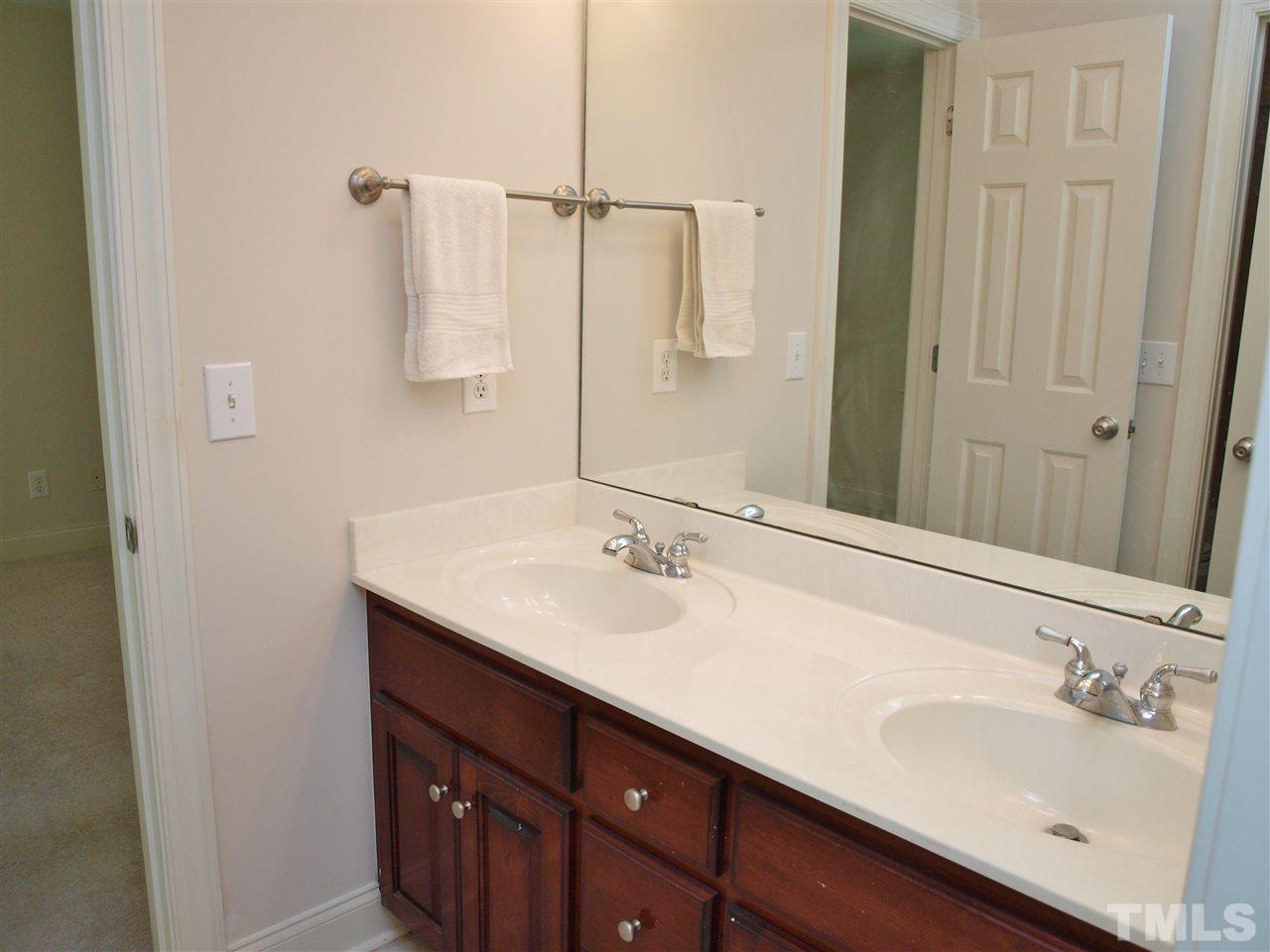 3317 La Costa Way Raleigh, NC 27610 - Photo 20 of 25 a bathroom with a sink and a mirror