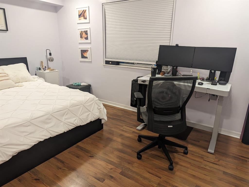 410 South Park Road, Unit 210 Hollywood, FL 33021 - Photo 3 of 5 a bedroom with a bed a chair and a potted plant on a table
