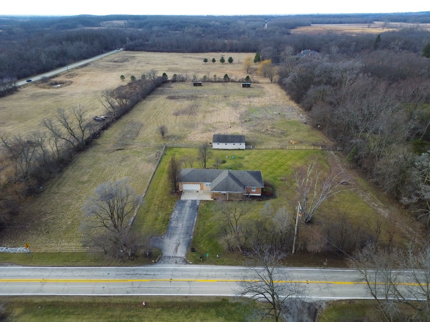 189 Old Sutton Road Barrington Hills, IL 60010 - Photo 3 of 24 a view of a dry yard with wooden fence