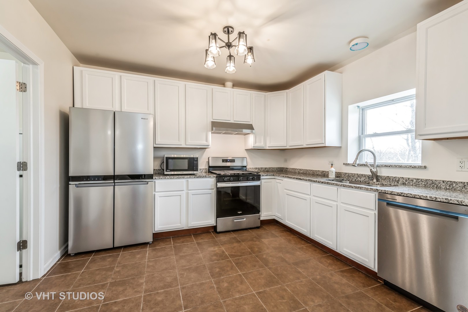 189 Old Sutton Road Barrington Hills, IL 60010 - Photo 8 of 24 a kitchen with a white cabinets and white appliances