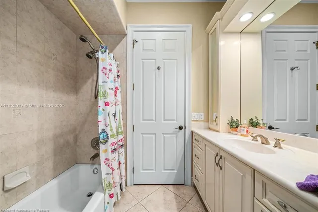 a spacious bedroom with a bed and a flat screen tv