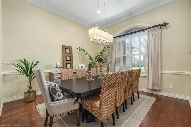 a kitchen with stainless steel appliances granite countertop a refrigerator a sink dishwasher a stove and white cabinets with wooden floor