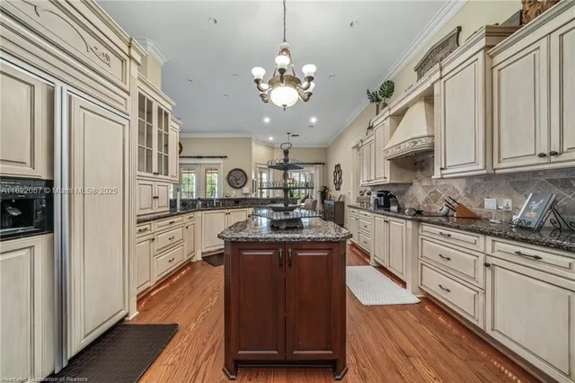 a kitchen with stainless steel appliances granite countertop cabinets and wooden floor