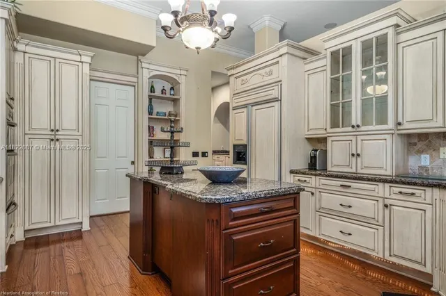 a kitchen with granite countertop a sink and cabinets