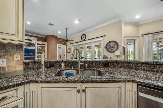 a kitchen with stainless steel appliances granite countertop a sink a stove and cabinets