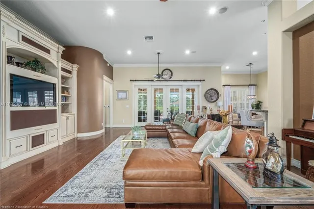 a living room with furniture and wooden floor
