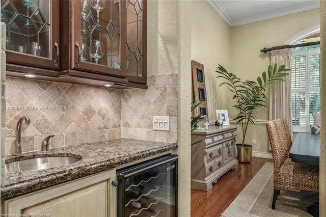 a kitchen with sink stove and cabinets
