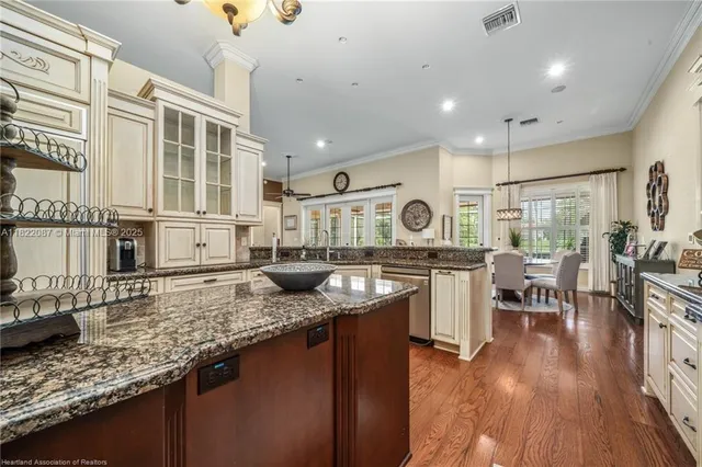 a kitchen with stainless steel appliances granite countertop a stove sink and cabinets