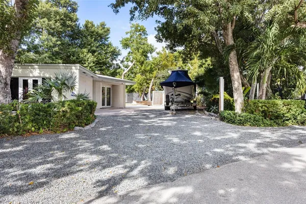 a view of a house with a tree in the background