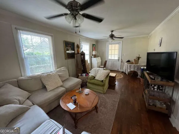 a living room with furniture and a flat screen tv