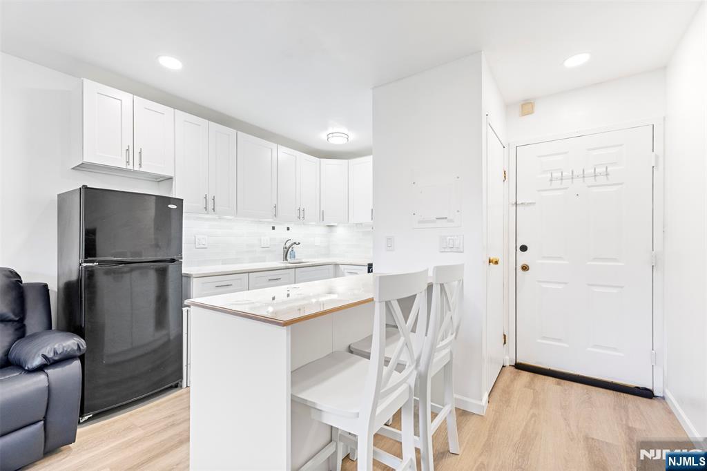 9 Vreeland Avenue, Unit 3A Hackensack, NJ 07601 - Photo 4 of 24 a kitchen with stainless steel appliances a refrigerator a sink a stove a microwave and island