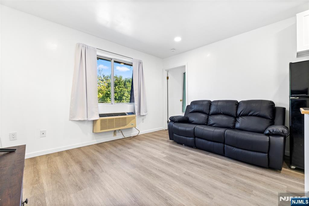 9 Vreeland Avenue, Unit 3A Hackensack, NJ 07601 - Photo 5 of 24 a living room with furniture and a window