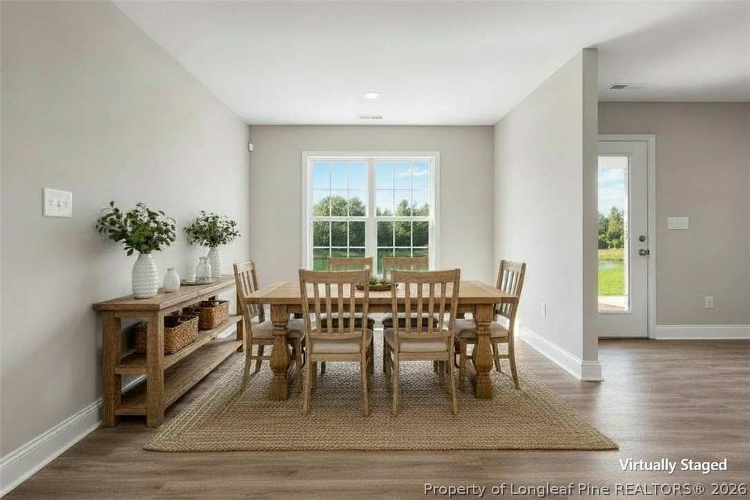 756 Jordan Road Autryville, NC 28318 - Photo 21 of 34 a view of a dining room with furniture and wooden floor