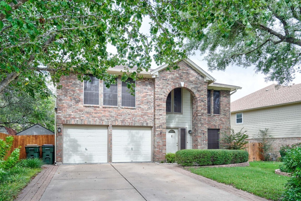 7604 Napier Trail Austin, TX 78729 - Photo 27 of 27 a front view of a house with a garden