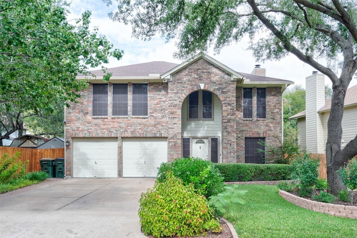 7604 Napier Trail Austin, TX 78729 - Photo 7 of 27 a front view of a house with a yard and garage