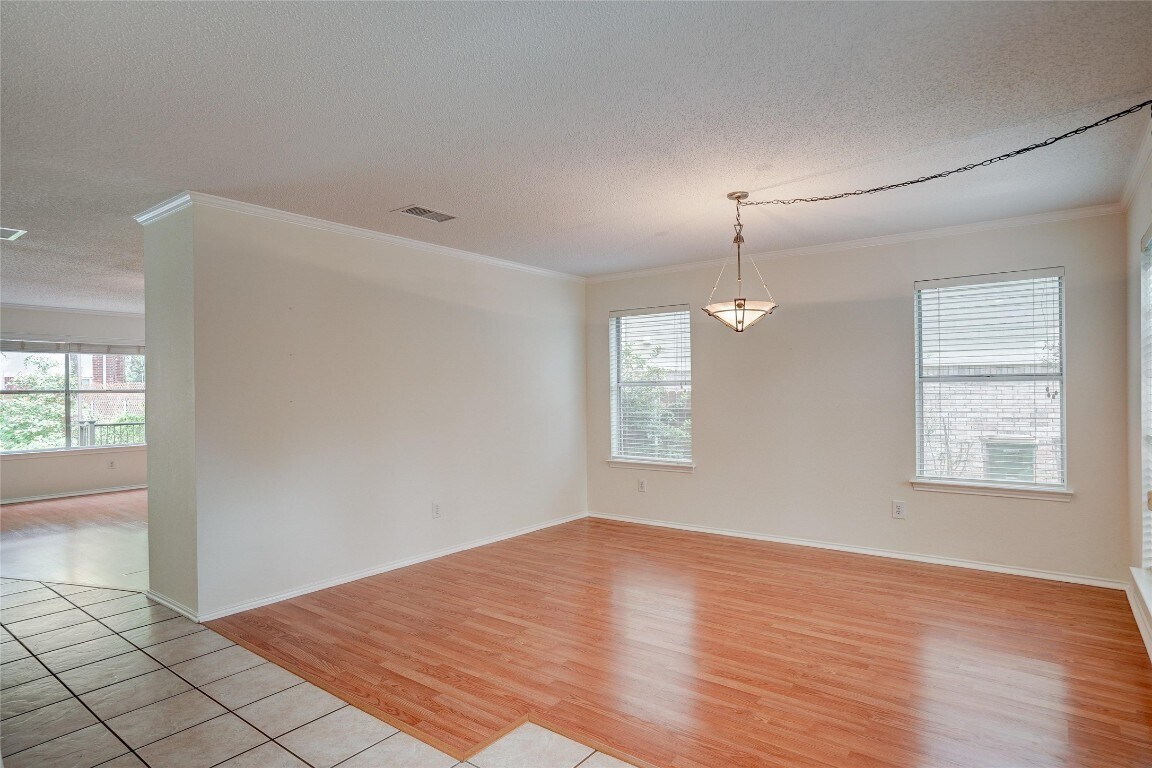 7604 Napier Trail Austin, TX 78729 - Photo 8 of 27 wooden floor in an empty room with a window