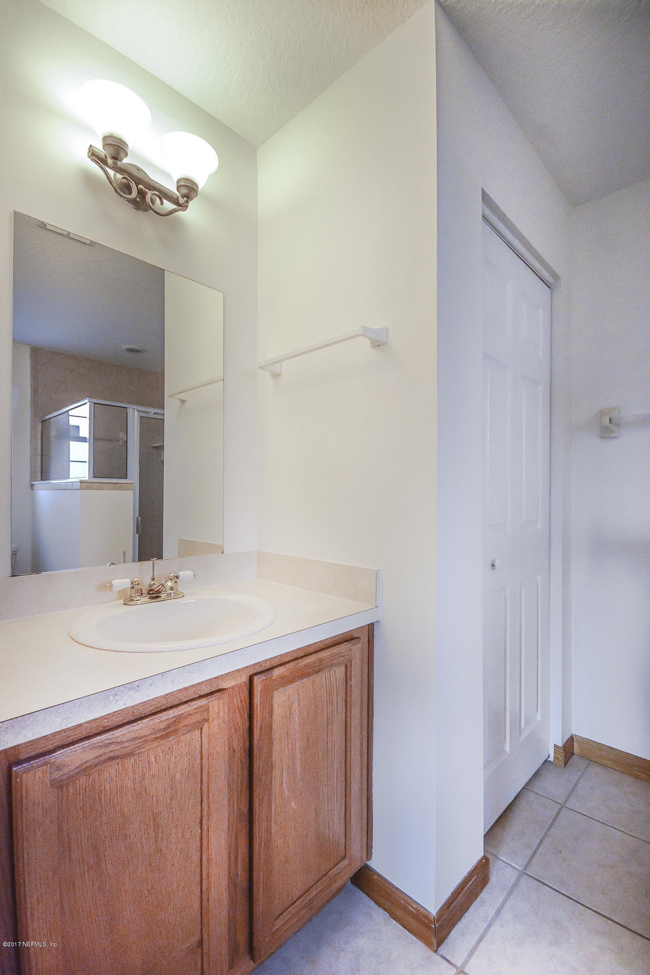 4822 Ricker Road Jacksonville, FL 32210 - Photo 25 of 50 a bathroom with a sink and a mirror