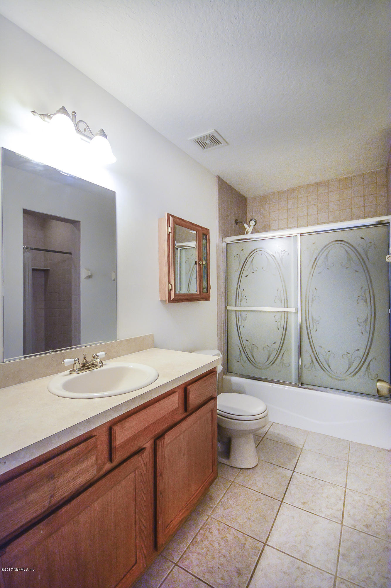 4822 Ricker Road Jacksonville, FL 32210 - Photo 29 of 50 a bathroom with a toilet a sink and mirror