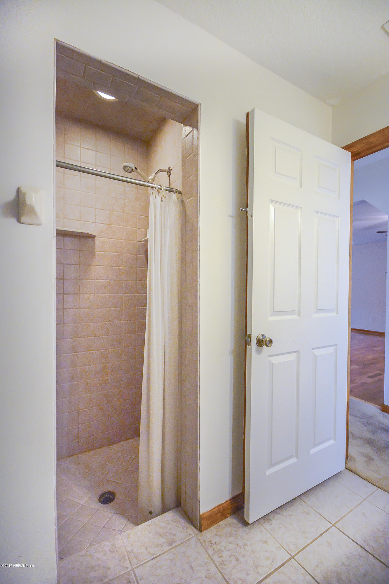 4822 Ricker Road Jacksonville, FL 32210 - Photo 30 of 50 a bathroom with a glass shower door
