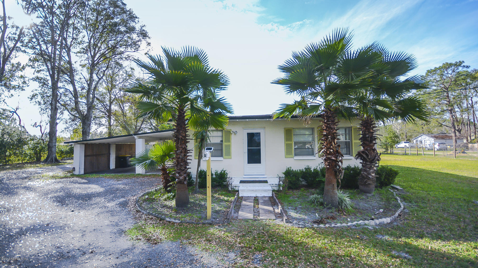 4822 Ricker Road Jacksonville, FL 32210 - Photo 33 of 50 a view of a house with backyard and a tree