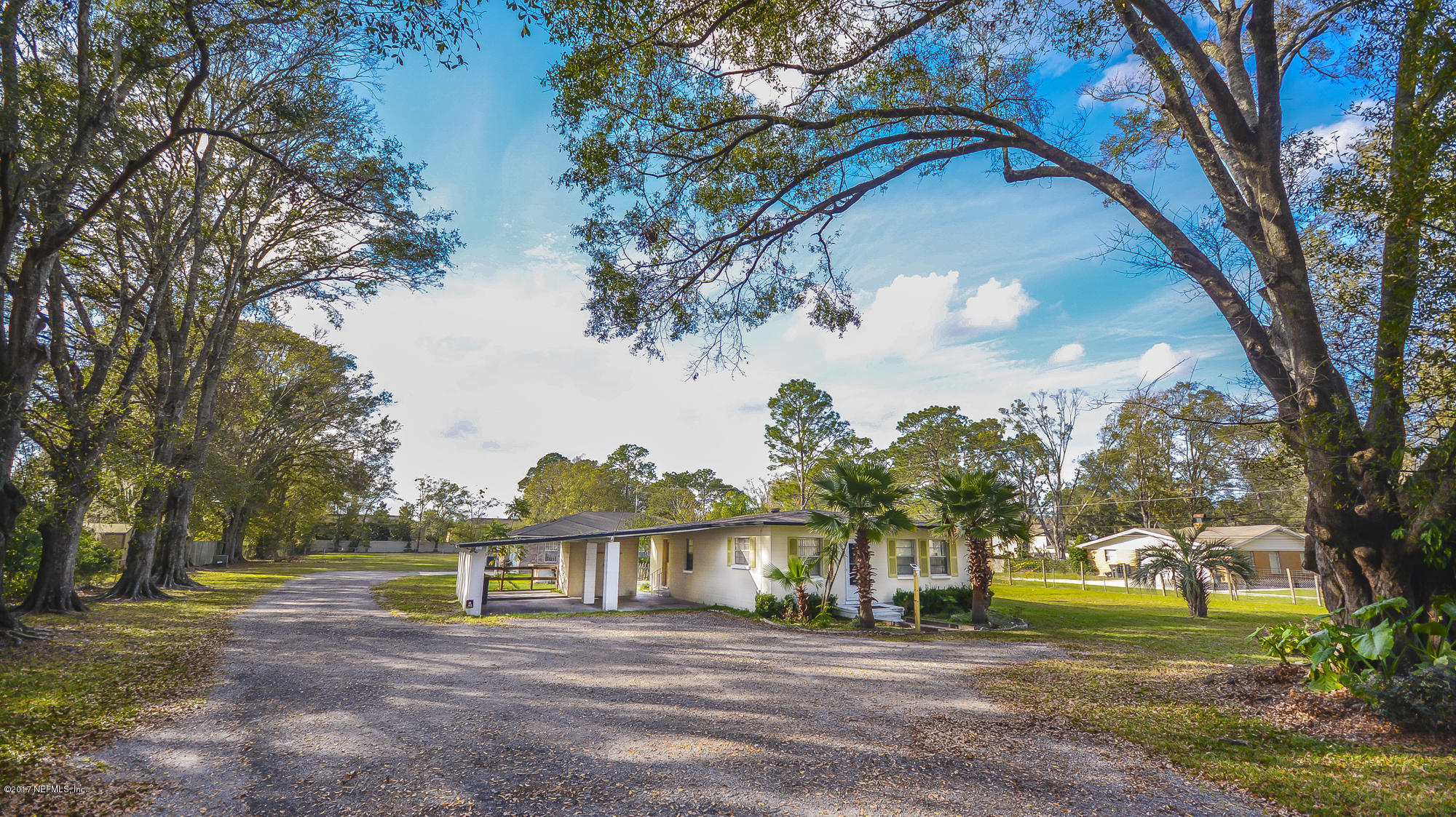 4822 Ricker Road Jacksonville, FL 32210 - Photo 34 of 50 a front view of a house with a yard and trees
