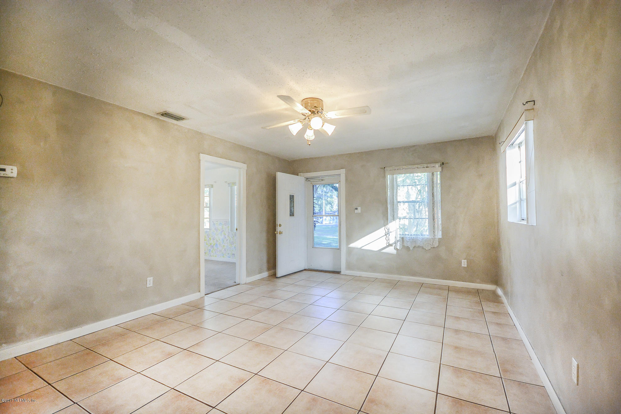 4822 Ricker Road Jacksonville, FL 32210 - Photo 37 of 50 a view of an empty room with a window