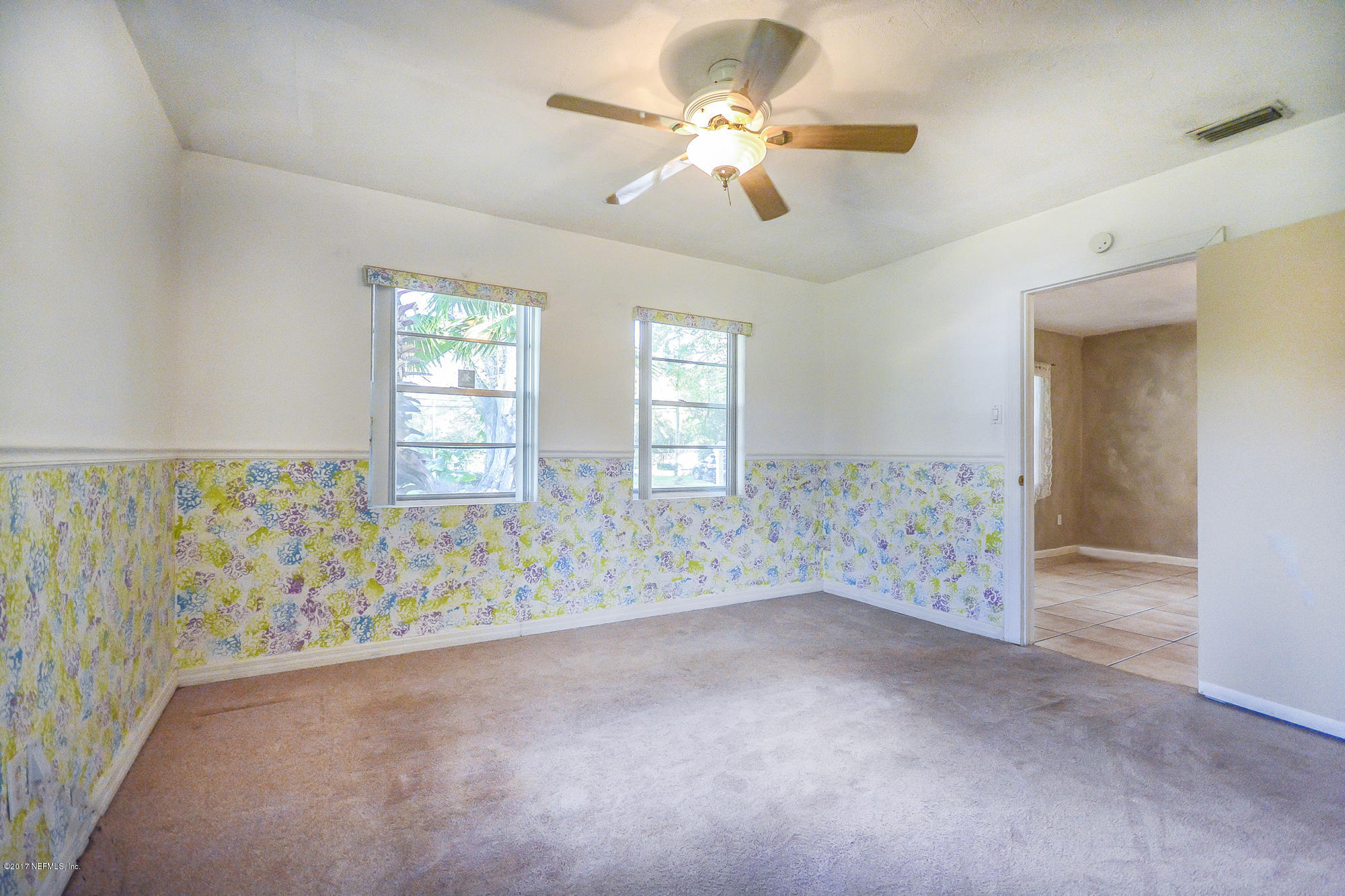 4822 Ricker Road Jacksonville, FL 32210 - Photo 43 of 50 wooden floor in an empty room with a window