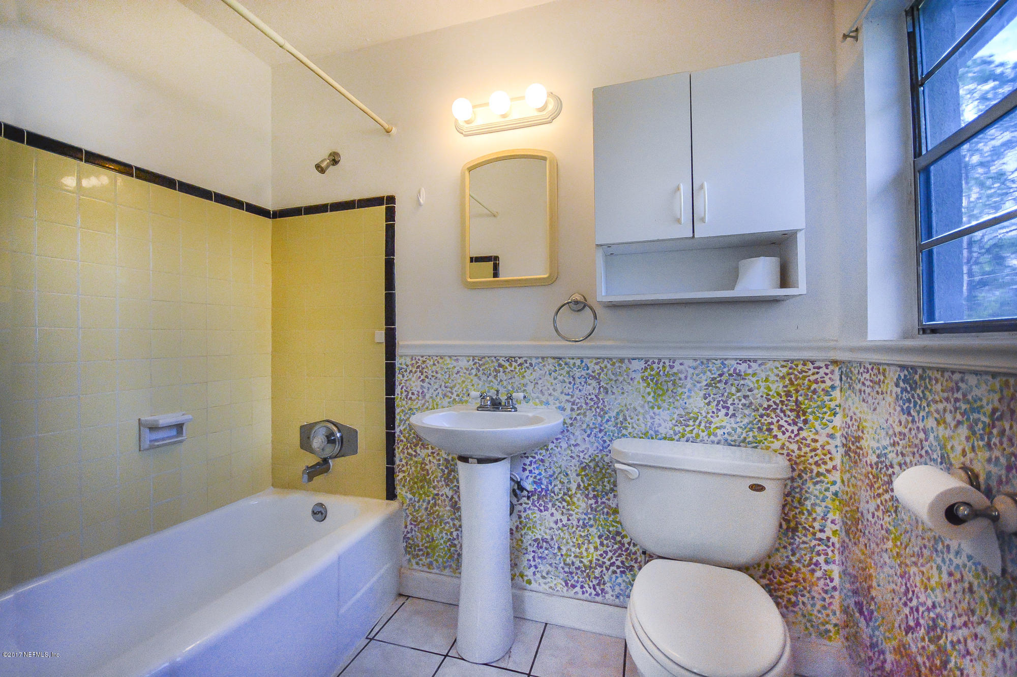 4822 Ricker Road Jacksonville, FL 32210 - Photo 44 of 50 a bathroom with a toilet sink and mirror